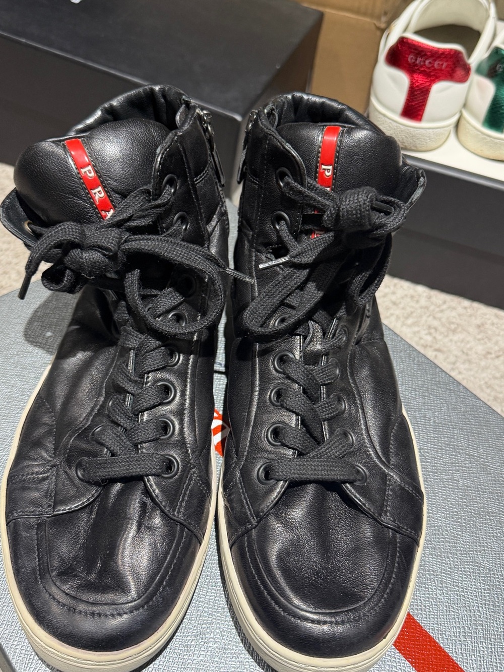 Prada Black Leather High-Top Sneakers with Red Logo Stripe